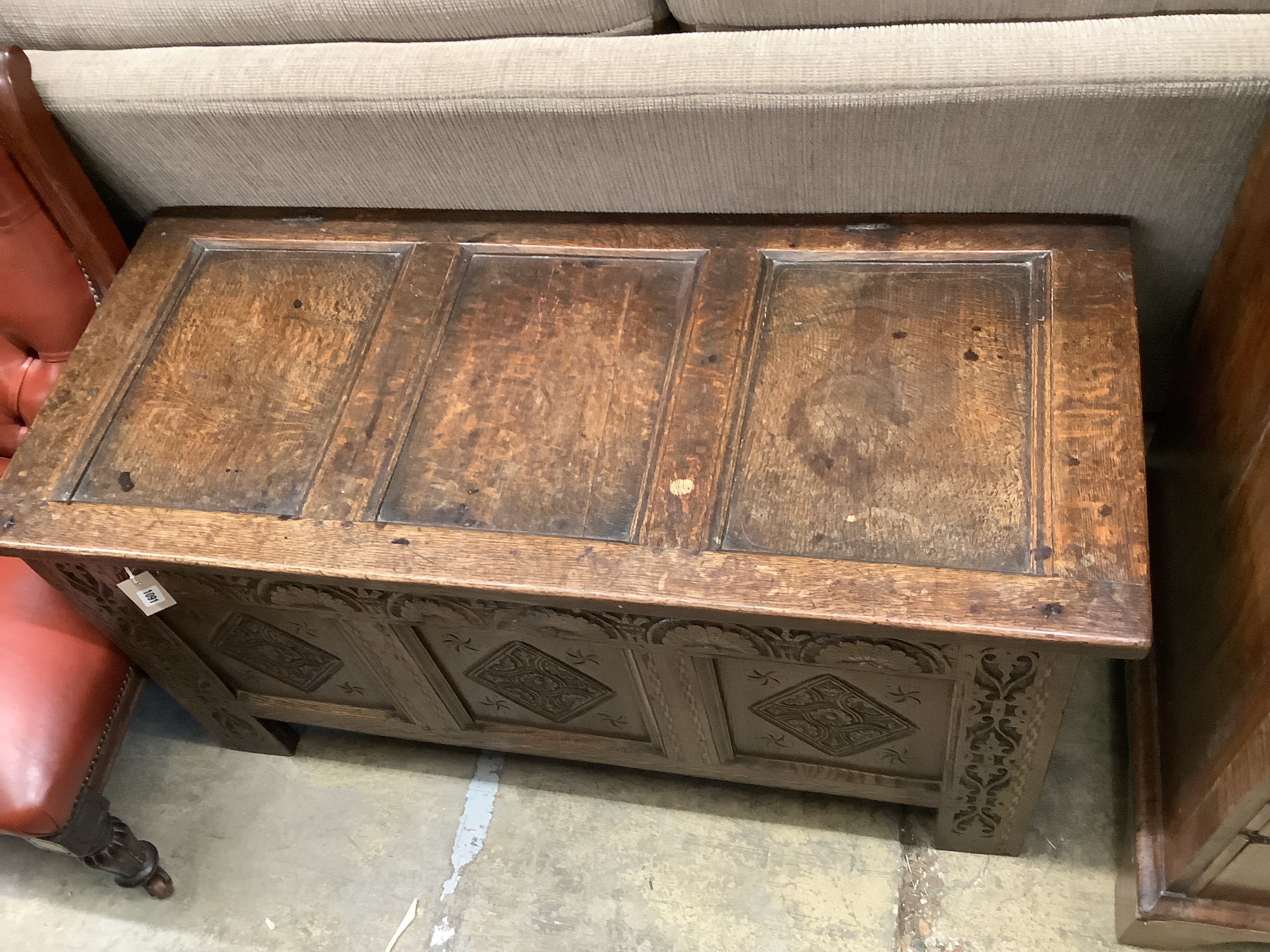 A 17th / 18th century panelled carved oak coffer, length 122cm, depth 53cm, height 61cm